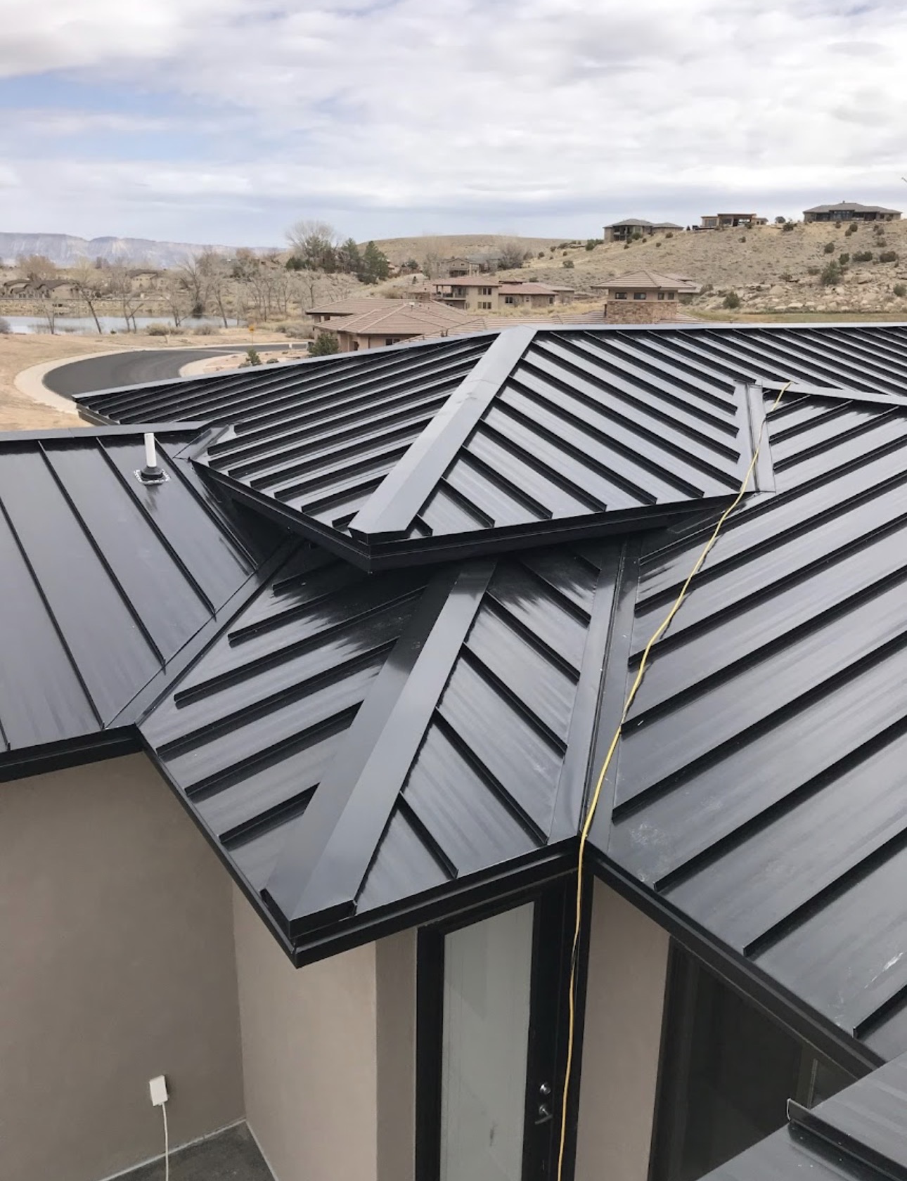 Finished metal roof section completed by Agile Roofing LLC