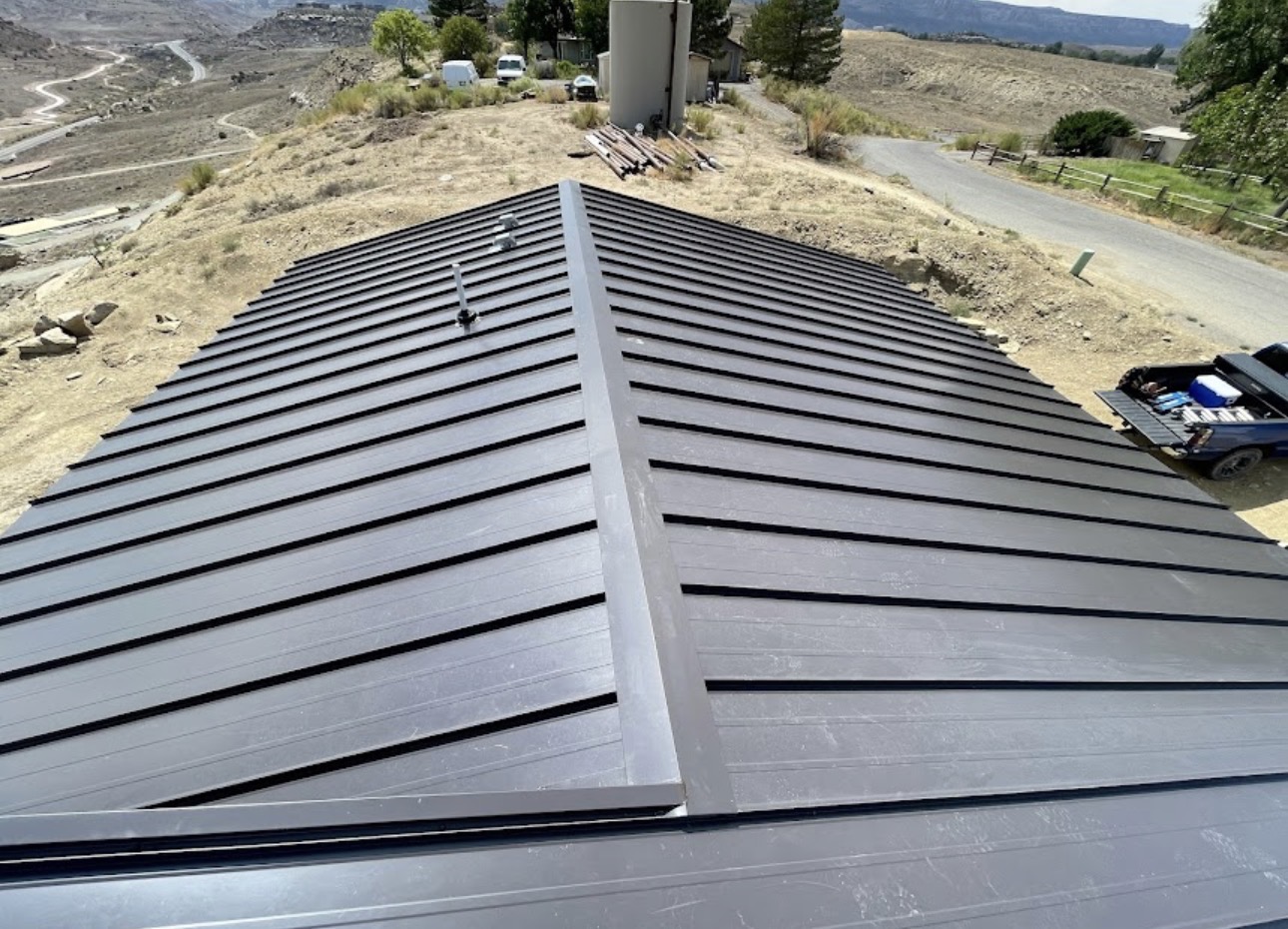 Finished metal roof ridge completed by Agile Roofing LLC